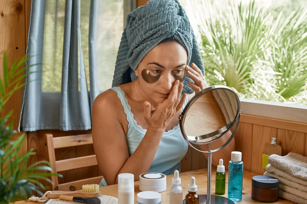 skincare routinemiddle age woman touching her face hydrogel eye patches looking mirror 1 - Online shopping in Sri Lanka